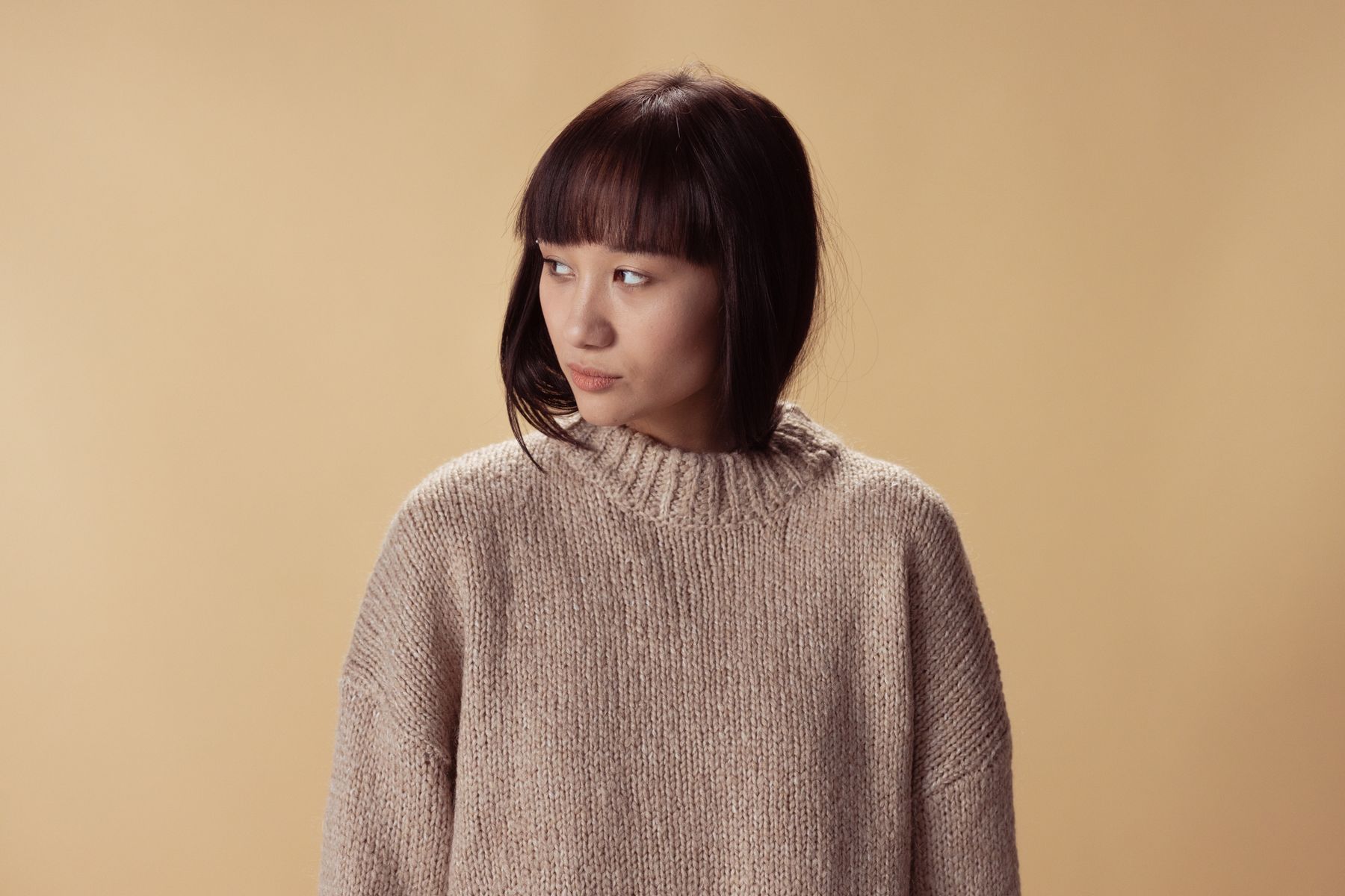 Model wearing ARRA oat knit
